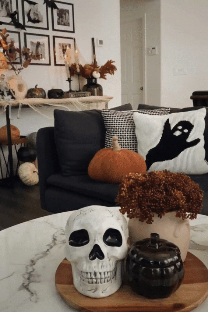 Halloween decor ideas with ghost pillow and skull on coffee table
