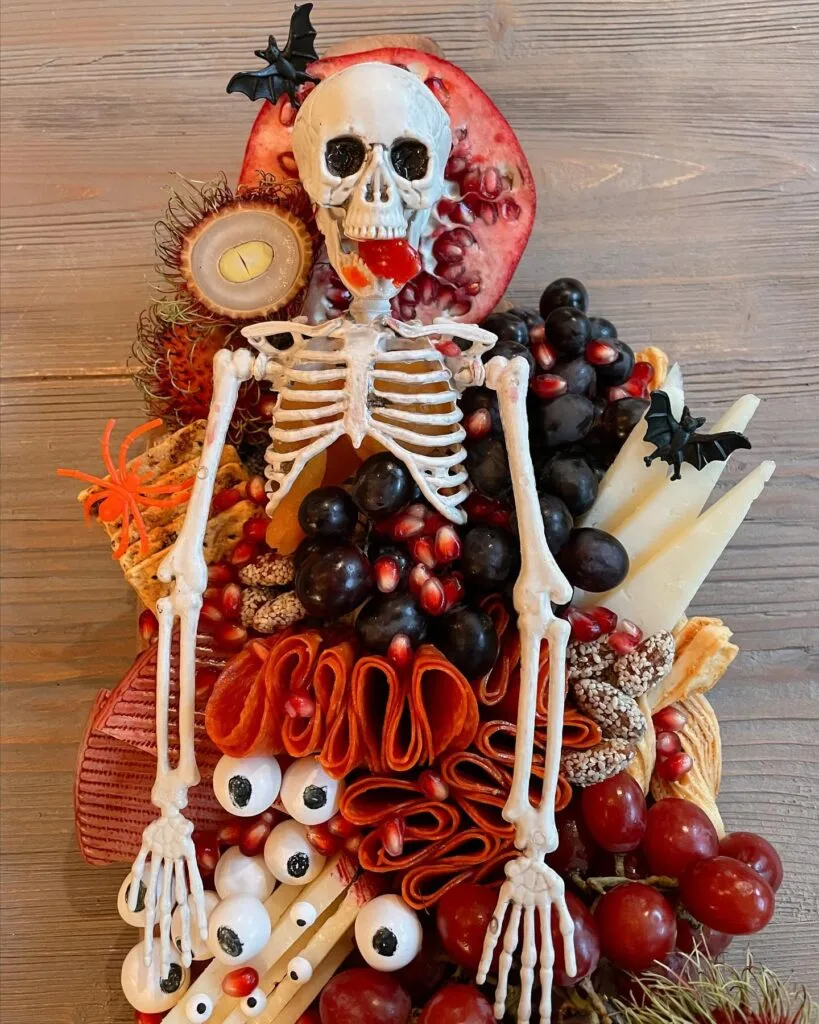 Halloween charcuterie board with full skeleton centerpiece