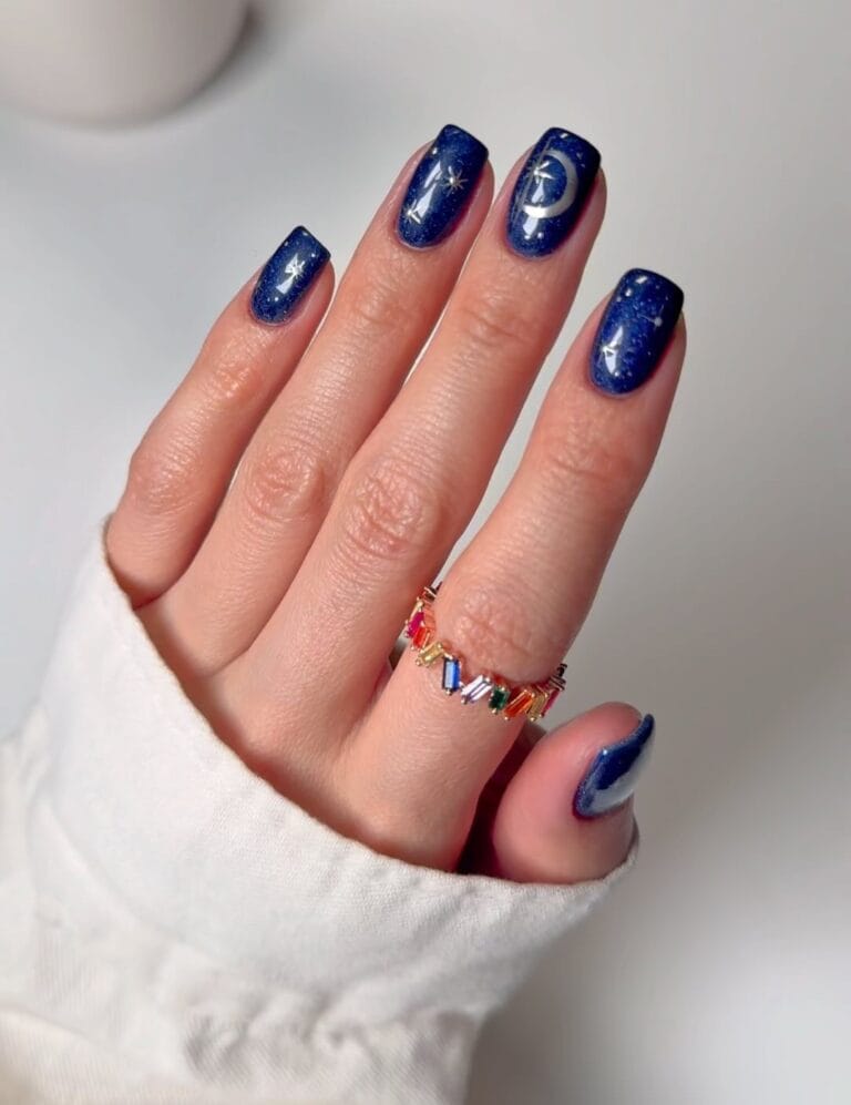 square navy glitter nails with gold moon and star nail art, witchy nail designs