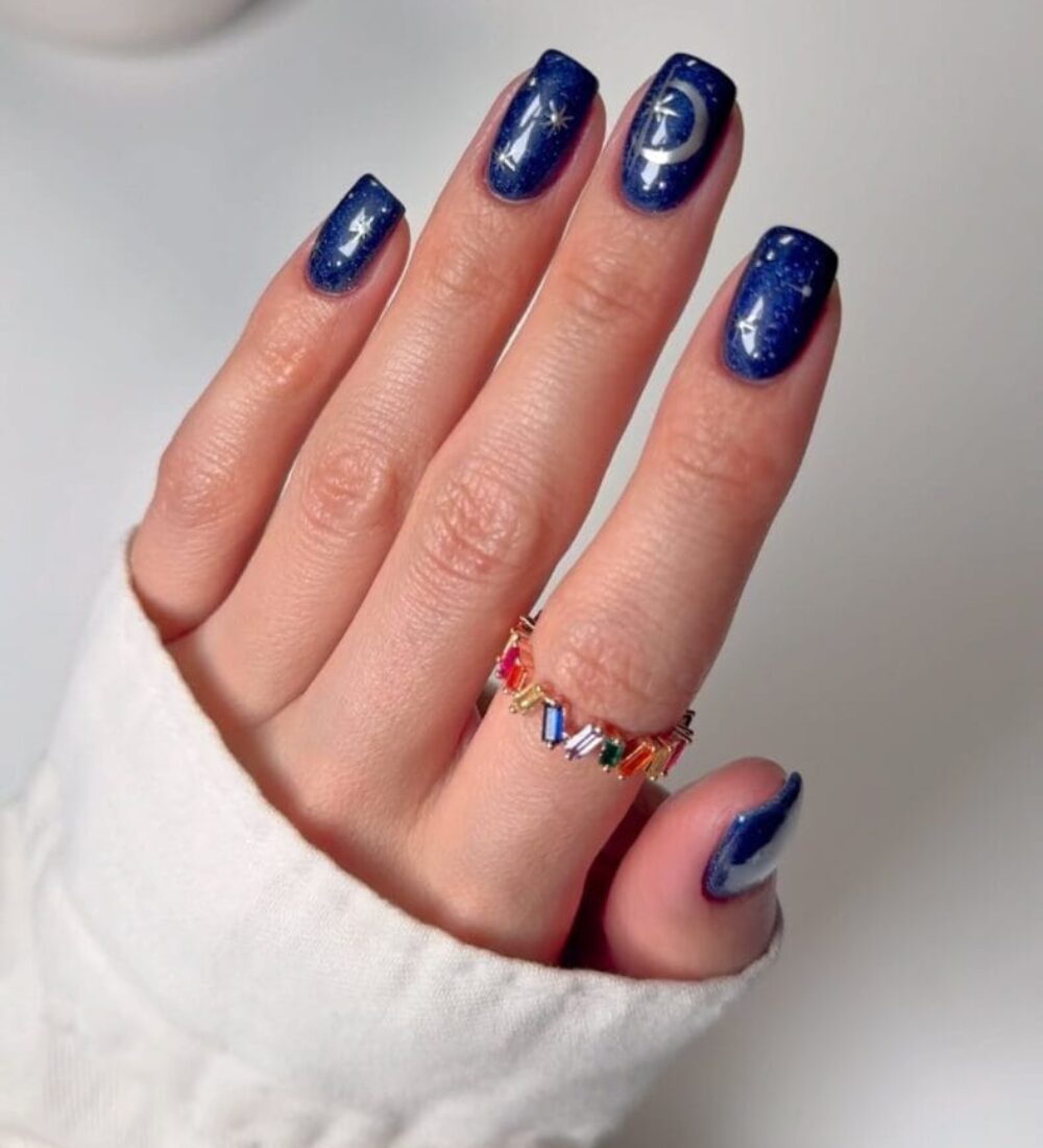 square navy glitter nails with gold moon and star nail art, witchy nail designs