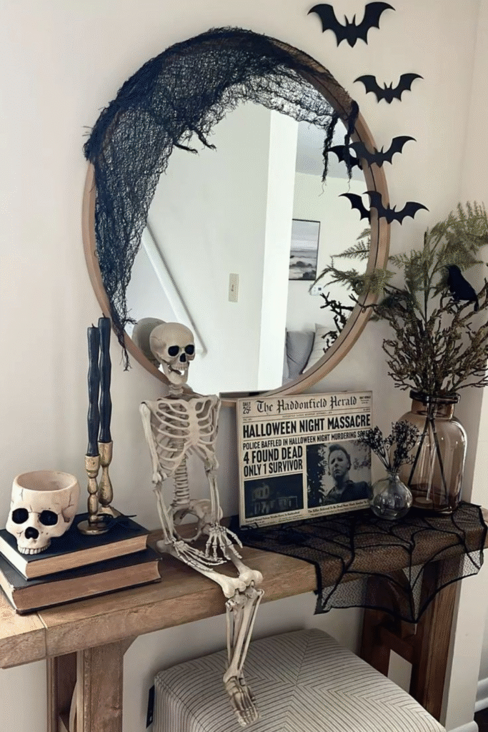 Skeleton Halloween decorations with mirror, bats and vintage newspaper