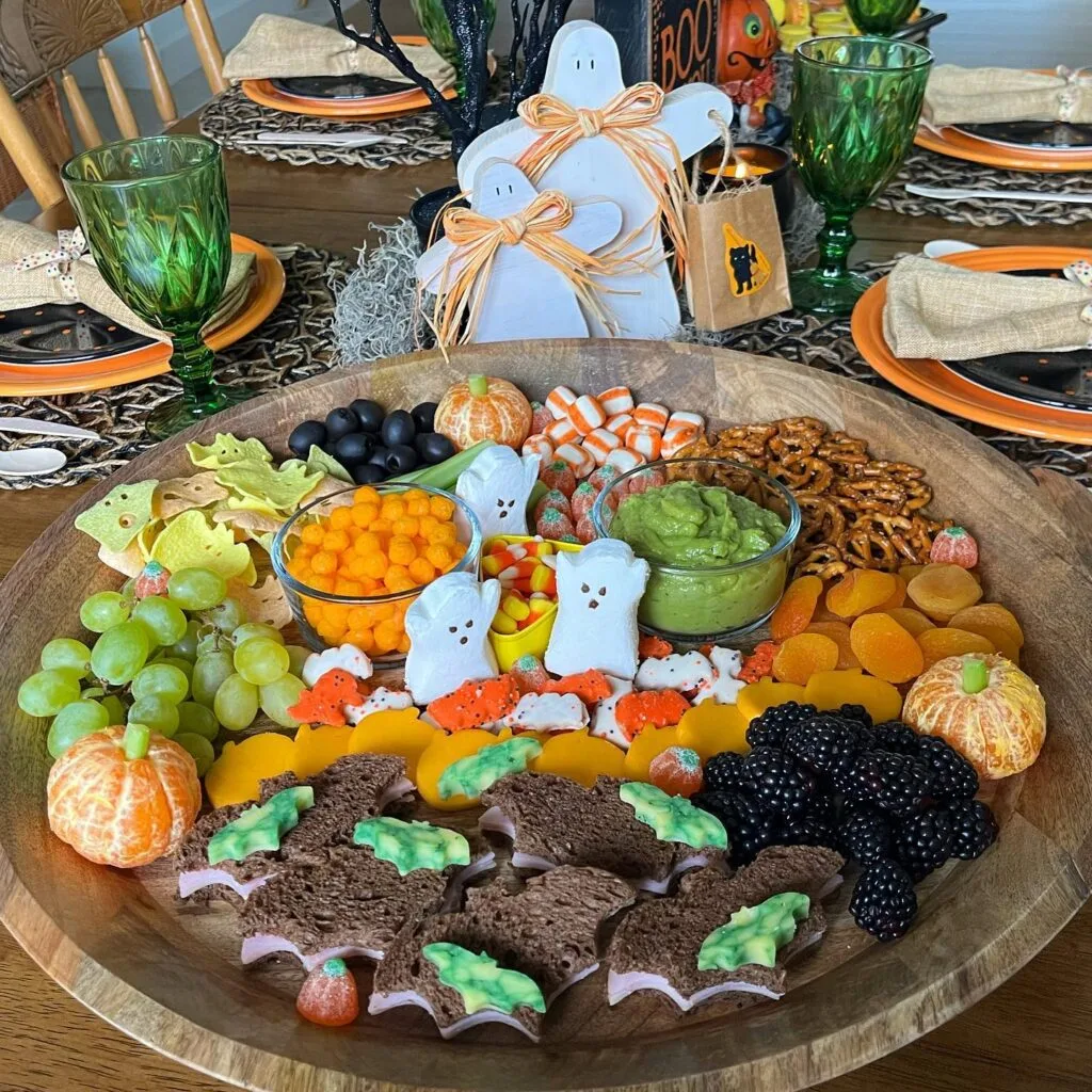 Halloween charcuterie board with ghost Peeps and bat sandwiches