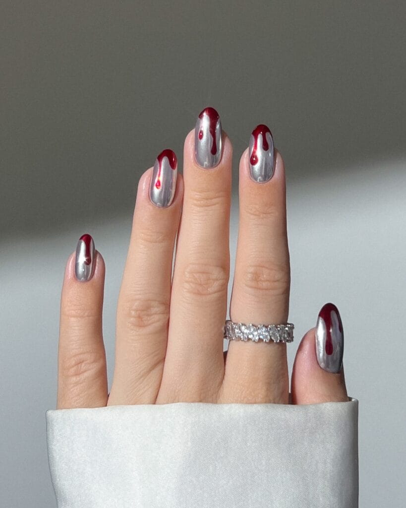 almond chrome silver nails with red drip nail art, Halloween nail design