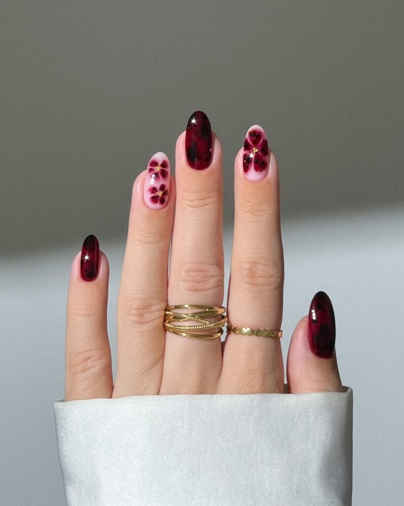 Burgundy floral nail art with stained-glass effect