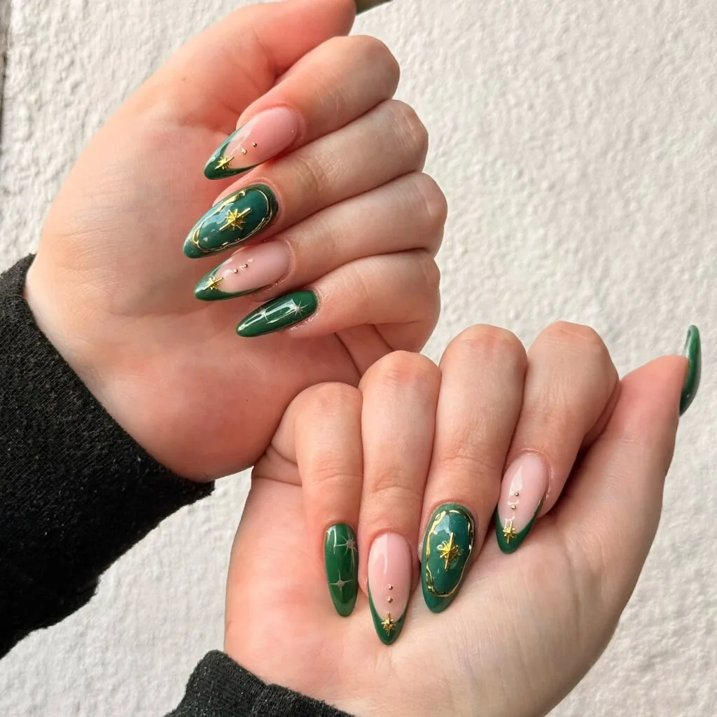 Dark green nails with nude base and gold star nail art accents