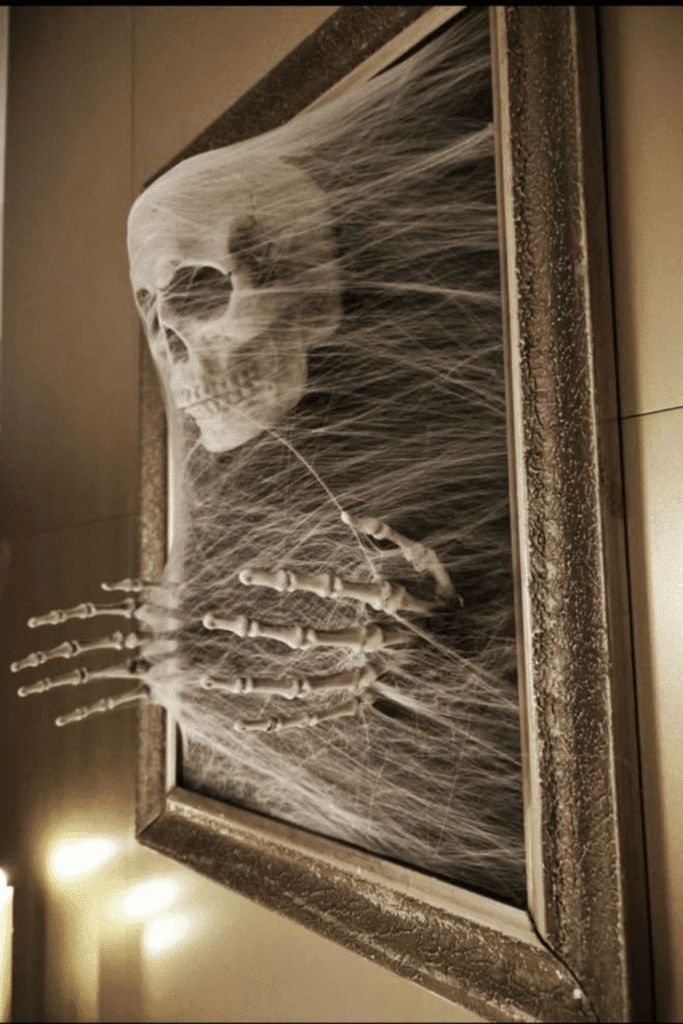 Framed skeleton hand Halloween decoration with spider web