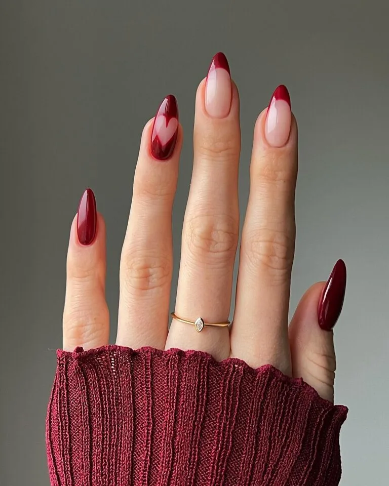 Burgundy French tip nails with heart accent design