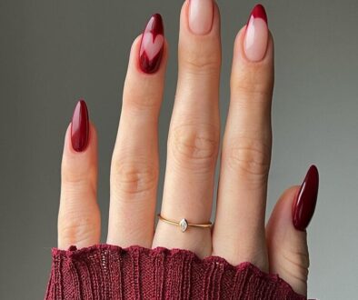 Burgundy French tip nails with heart accent design