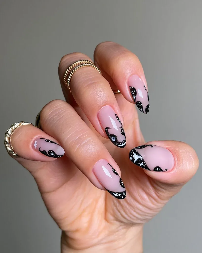 pink almond nails with black wavy French tips and tiny white bats and stars, spooky chic Halloween nails