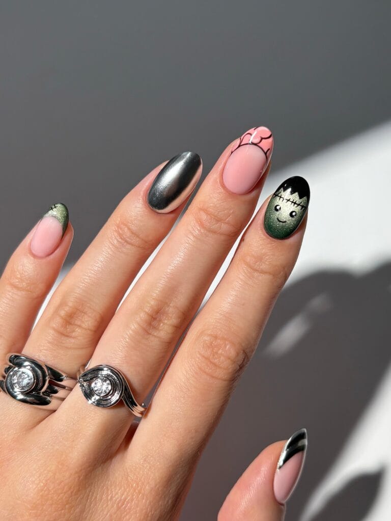 Halloween nails with silver chrome, pink brain French tip and glitter green Frankenstein accent nail