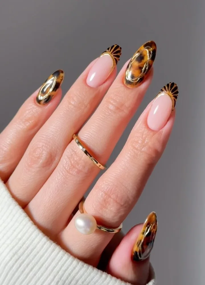Tortoiseshell French tip November nails with gold fan detail, almond shape, chic fall manicure