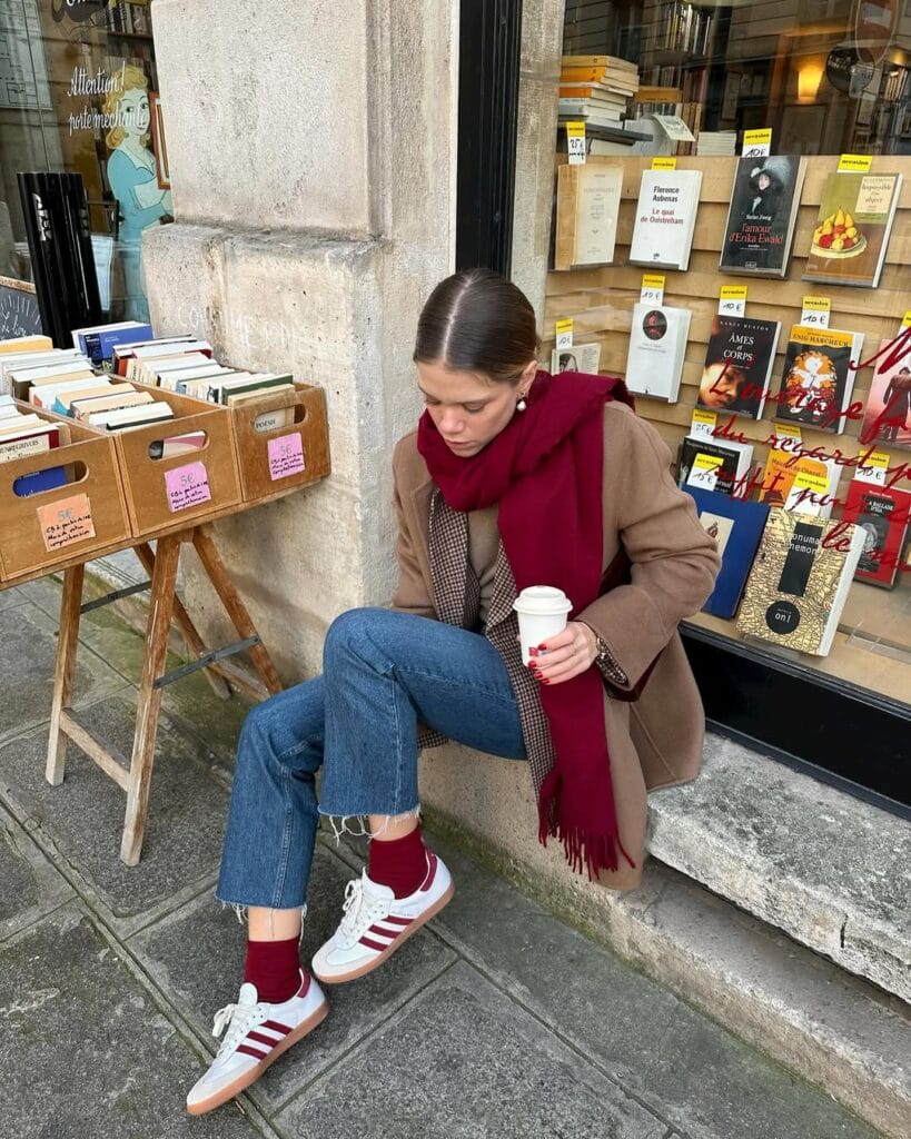 winter paris winter outfit with camel coat, burgundy scarf, and boots
