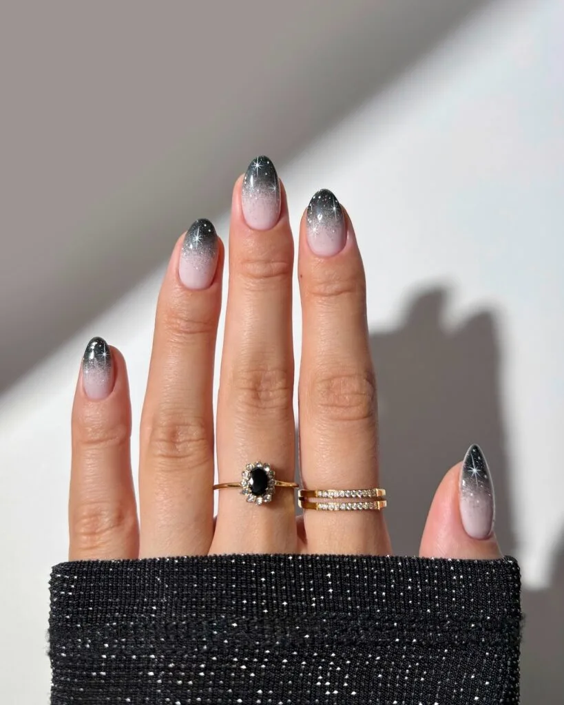 Black and white ombré French tips with sparkle" winter nail trends, frosted French