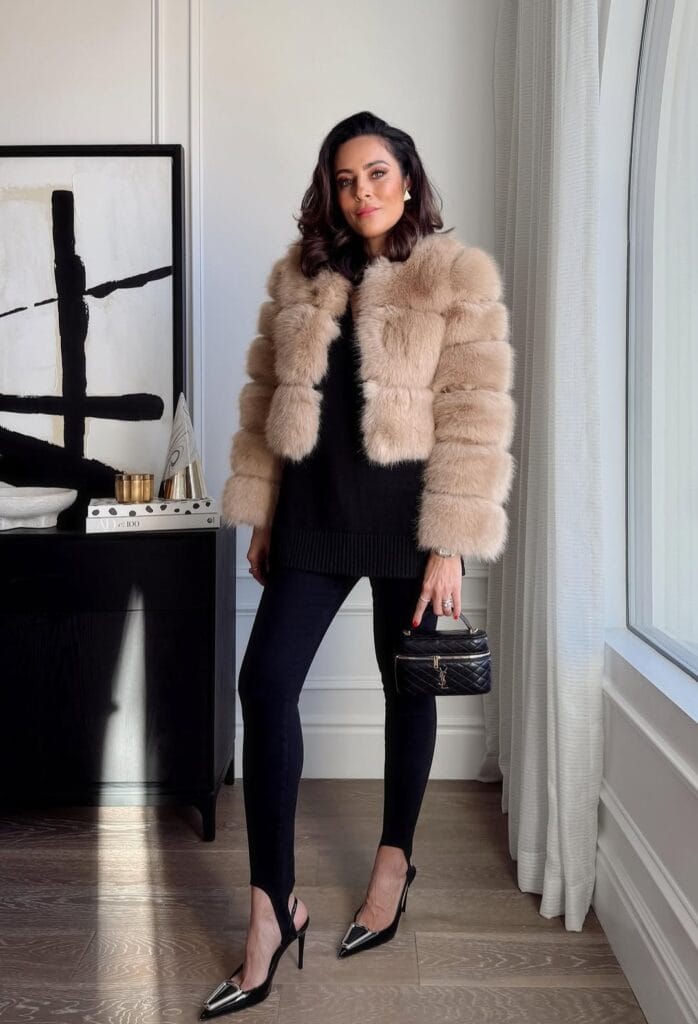winter date outfit with beige fur jacket, black sweater, black pants, heels

