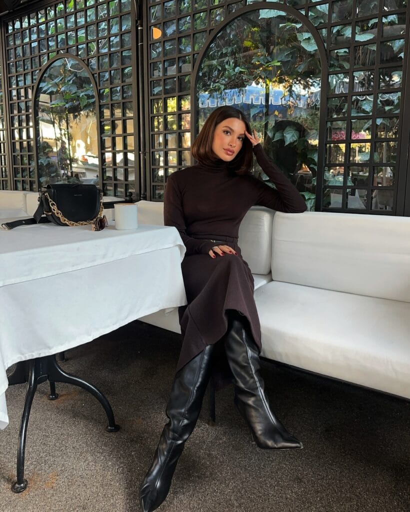 winter date outfit with brown turtleneck, brown pants, black knee-high boots
