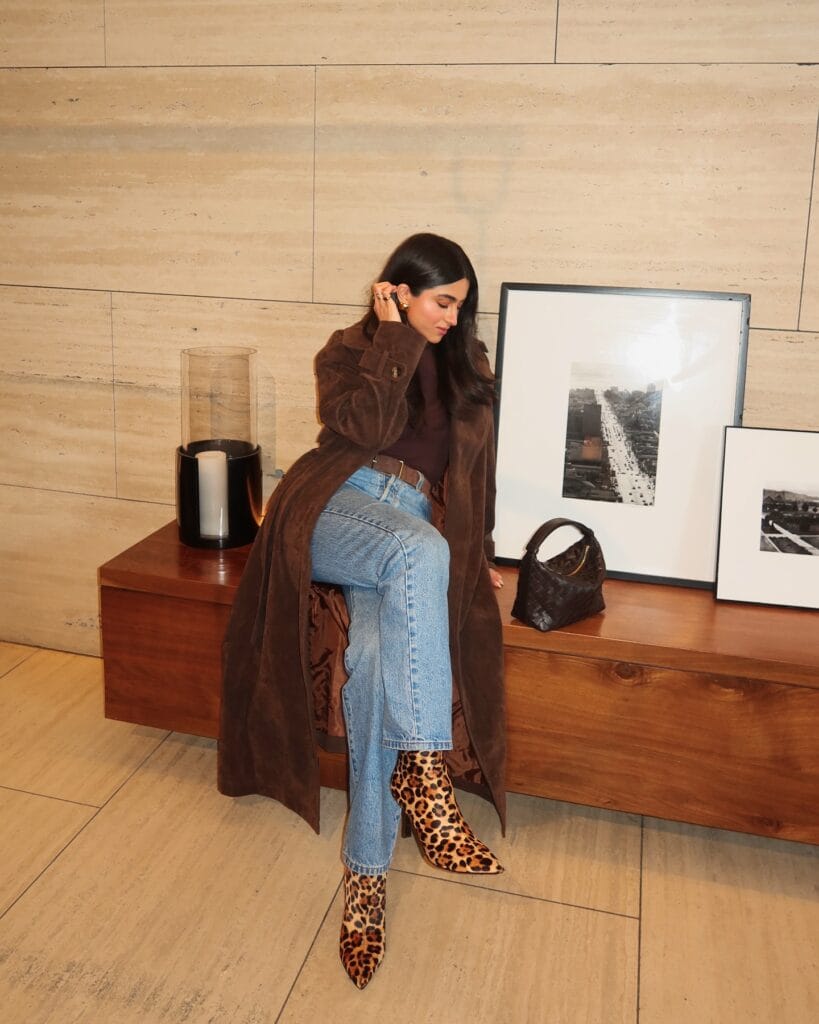 winter date outfit with brown coat, brown turtleneck, jeans, leopard boots
