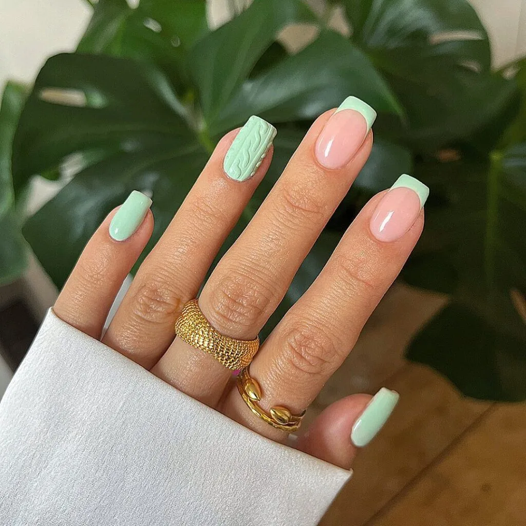 nude nails and mint French tips plus sweater-texture accent; simple winter nails.