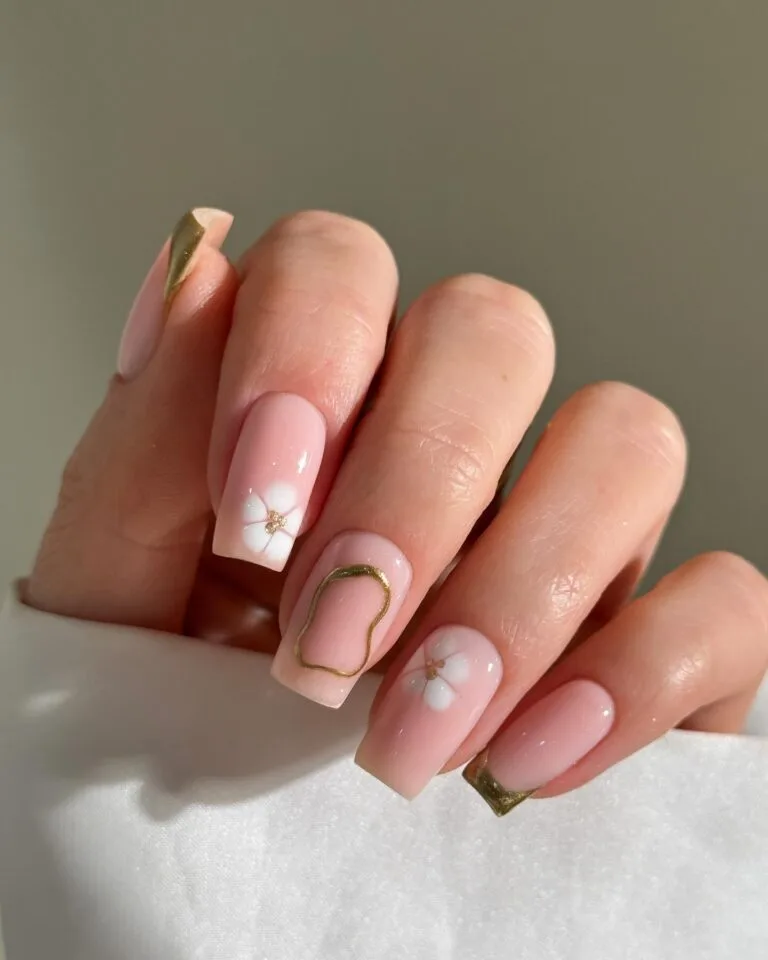 pink nails with white floral and gold outline, December nail ideas