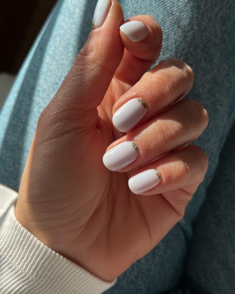 short winter nails in white with gold crystal curve detail, square shape