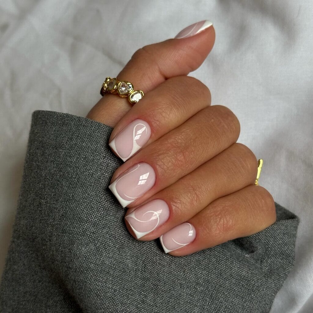 short winter nails, nude pink with white abstract flame design, square shape, silver rings