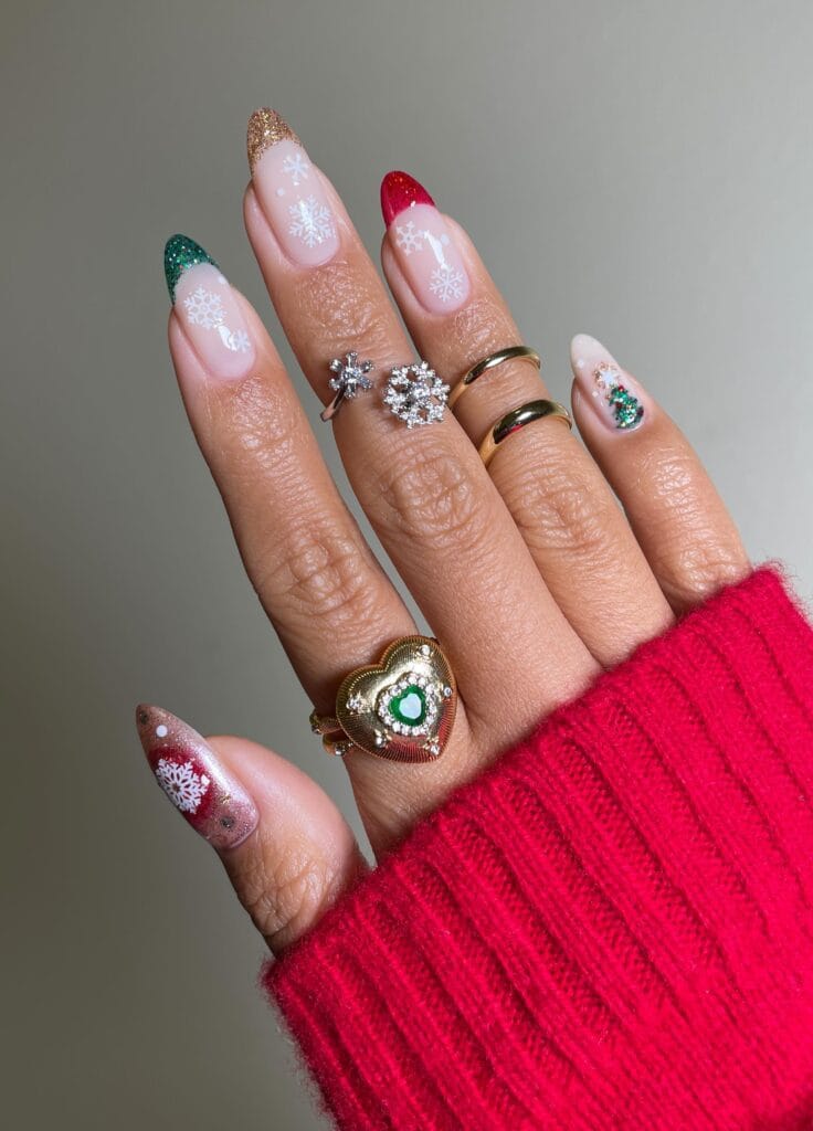 almond nails with green, gold, red French tips, snowflakes, and Christmas tree, holiday nail art