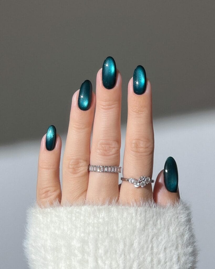 Teal cat-eye velvet magnetic nails with sheen" winter nail trends, plush velvet effect