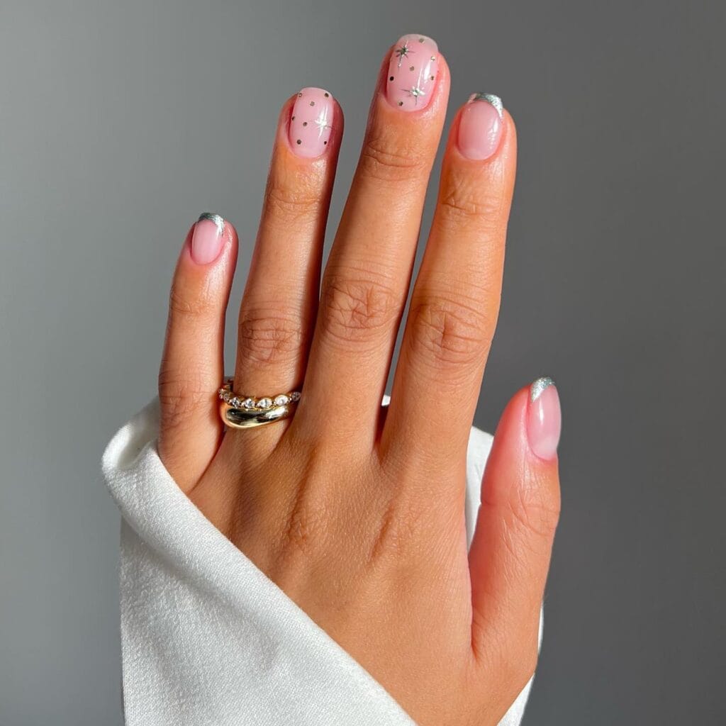 short nude nails with silver French tips and star accents, Christmas nails