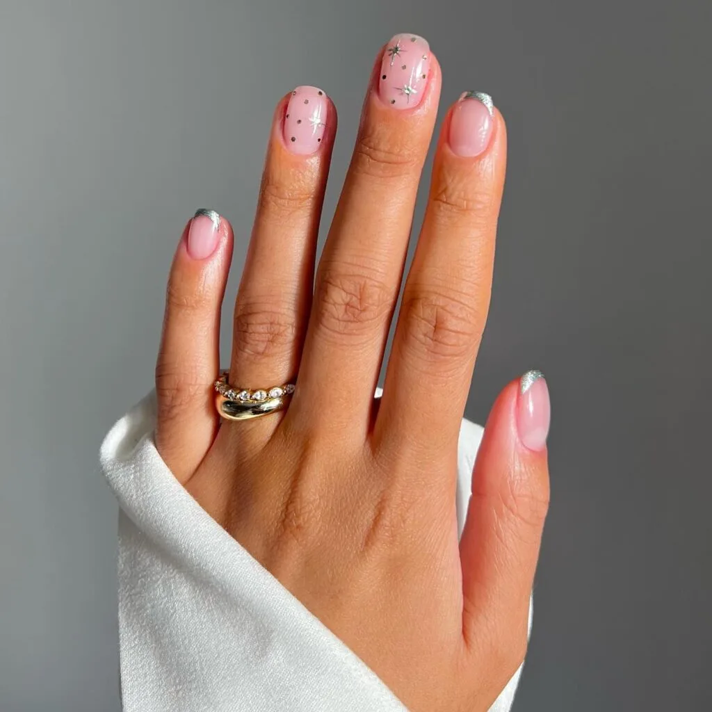 short nude nails with silver French tips and star accents, Christmas nails