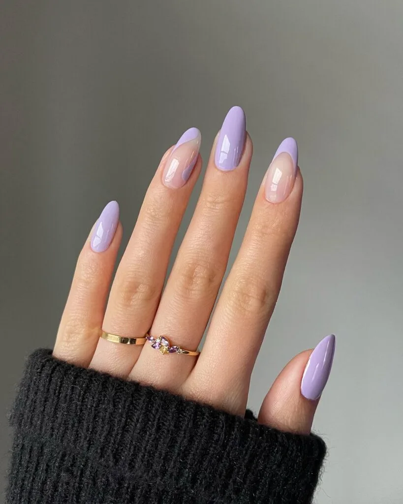 Pastel lavender manicure with French tips and one solid lavender accent nail, simple winter nails.