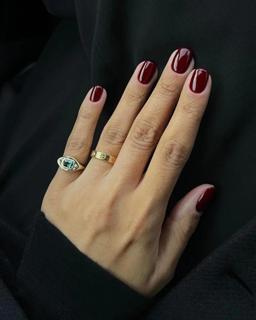 Deep burgundy red glossy manicure, simple winter nails.