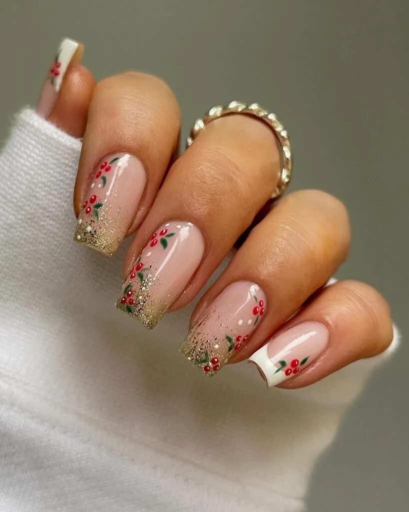 nude nails with gold glitter, red berry nail art, and white French tip accent, Christmas nails