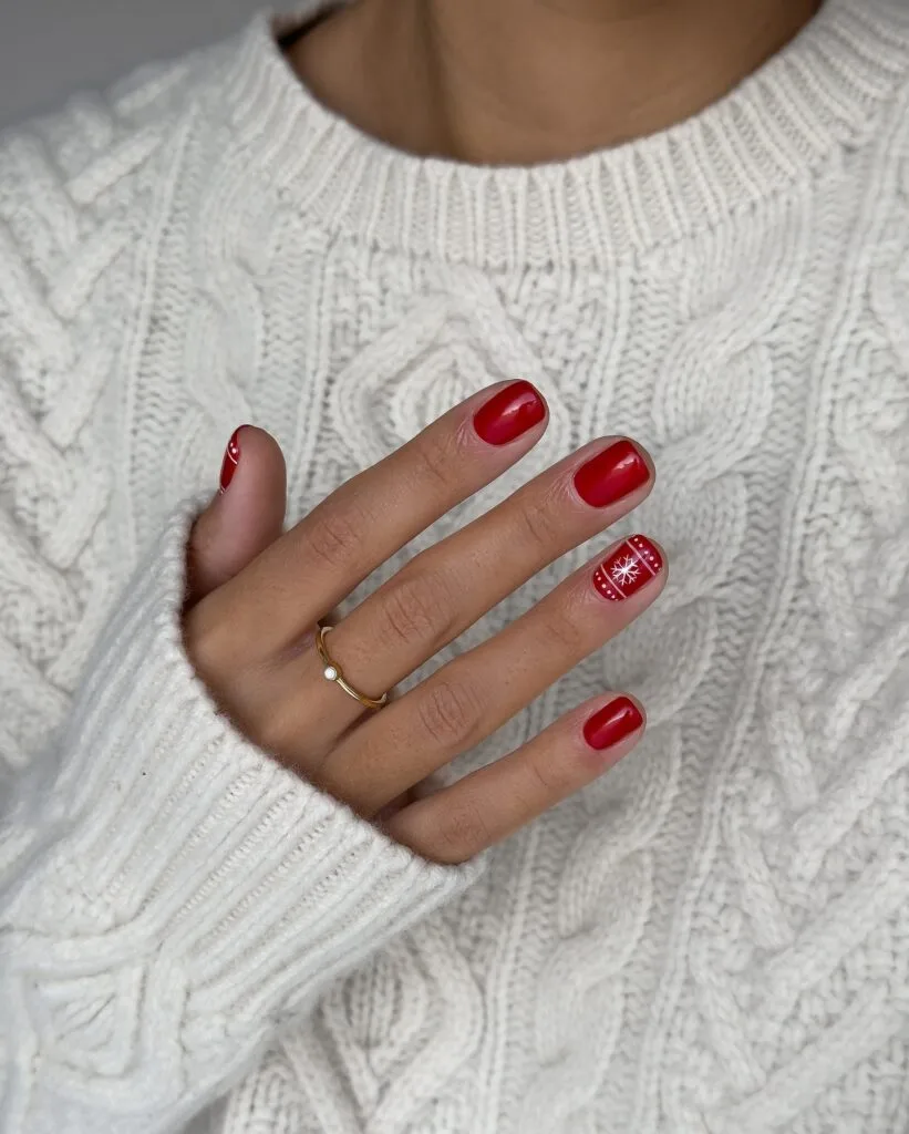 short red nails with white snowflake accent nail, Christmas knit sweater background