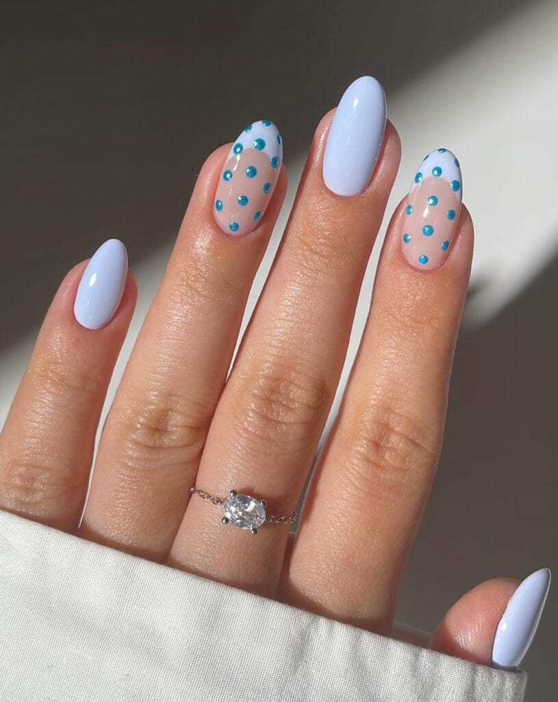 Light blue nails with turquoise polka dots" winter nail trends, playful dot design