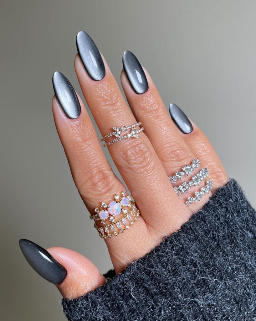 Long almond gray cat-eye nails with soft shimmer" winter nail trends, stormy stone