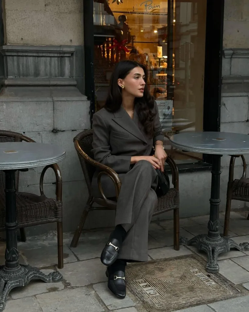 winter work outfit with grey blazer and trousers, black loafers, black socks, minimalist accessories

