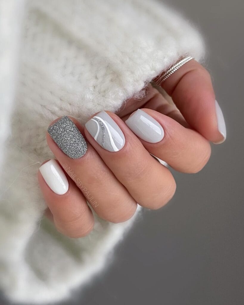 Short winter nails with white and silver, glitter accent" winter nail trends, stormy gray stone