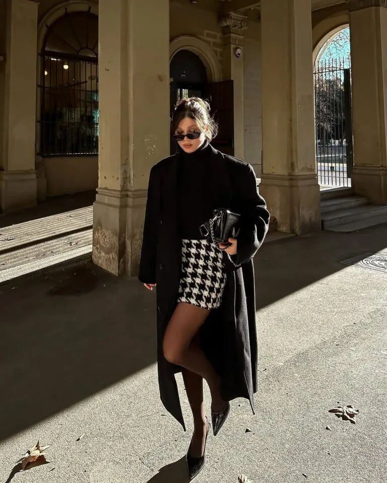 old money winter outfit with black coat, houndstooth skirt, black turtleneck