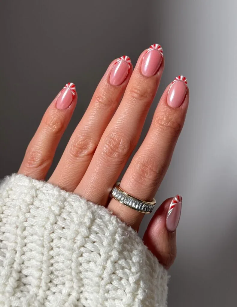 pink nails with red and white peppermint swirl French tips, Christmas nails