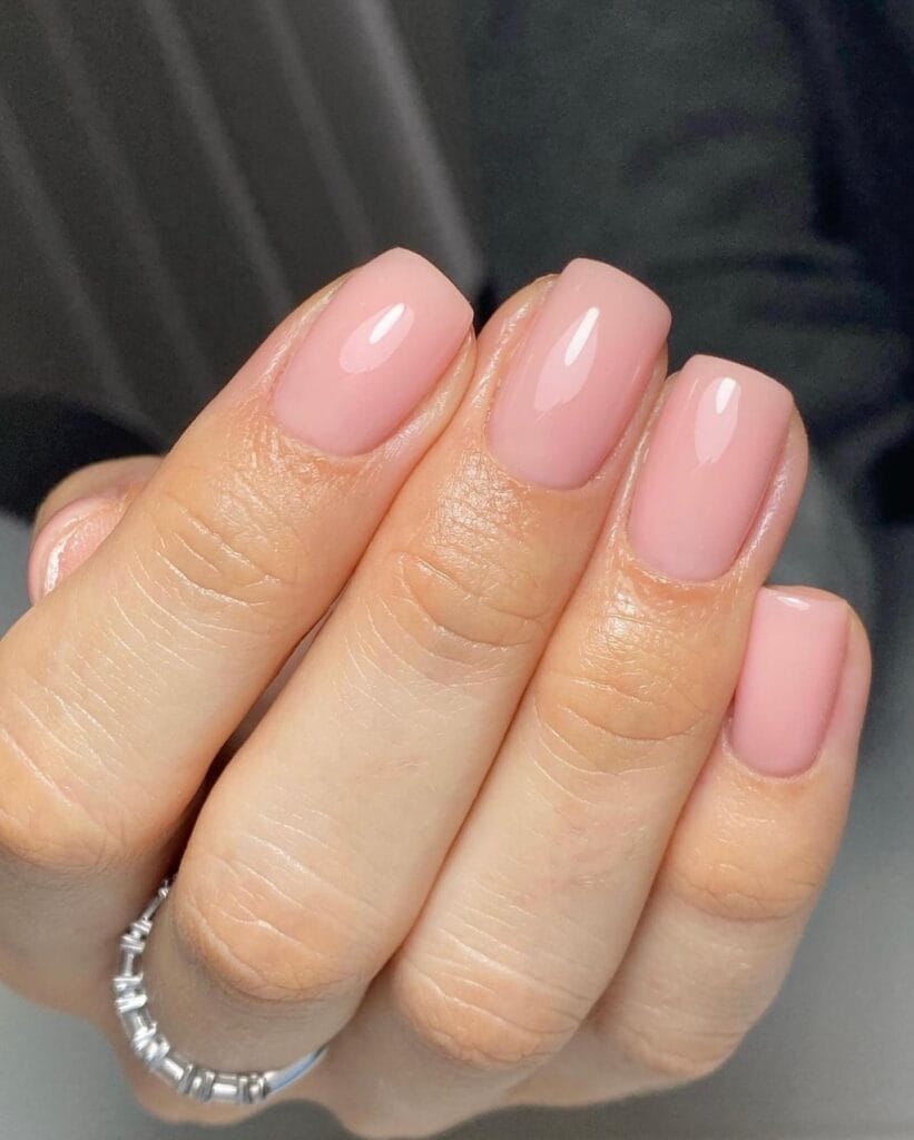 trendy nails in soft sheer pink, short square shape with glossy finish and silver ring