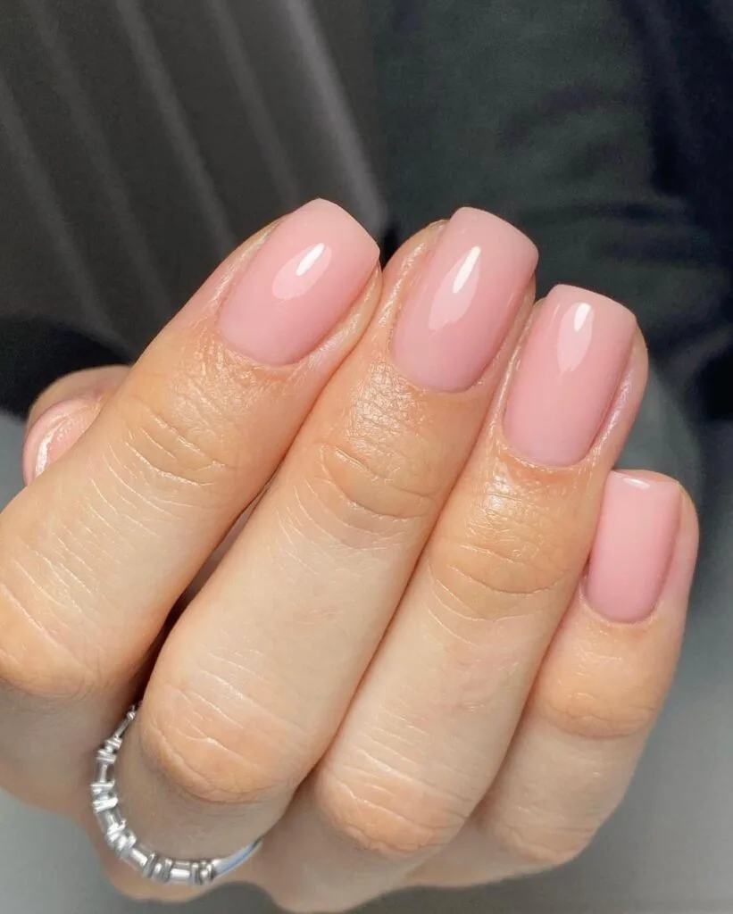 trendy nails in soft sheer pink, short square shape with glossy finish and silver ring