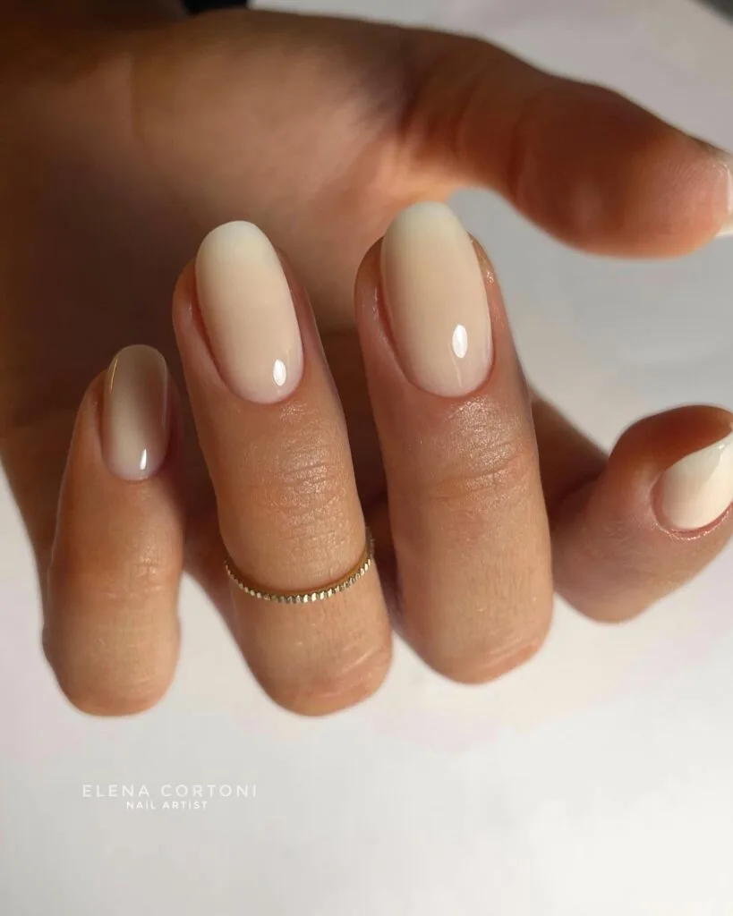 2026 nail trends, creamy vanilla almond nails with gold midi ring