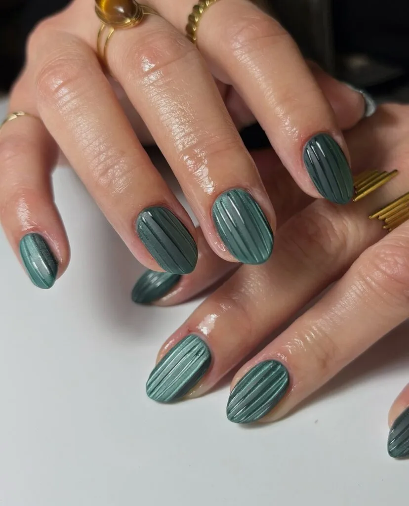 2026 nail trends, glass nails in teal green with vertical stripe texture and gold rings