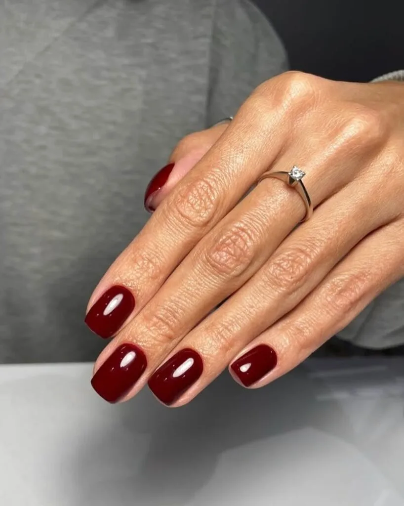 nail colors for 2026, short square nails in chocolate cherry with glossy finish and diamond ring