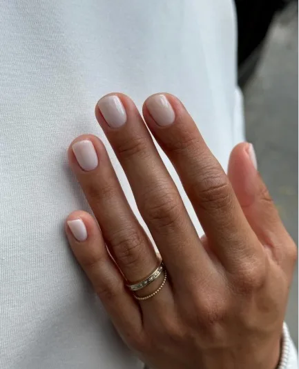 nail colors for 2026, short rounded nails in soft white with gold stacked rings