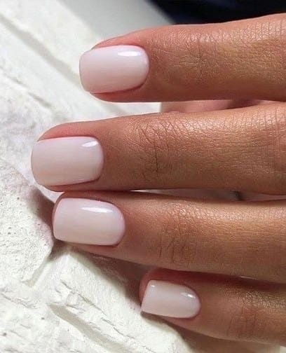trendy nails in milky white, short rounded shape with glossy finish