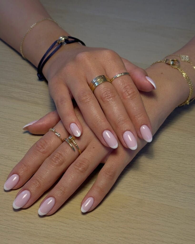 2026 nail trends, soft cloud pink oval nails with layered gold rings