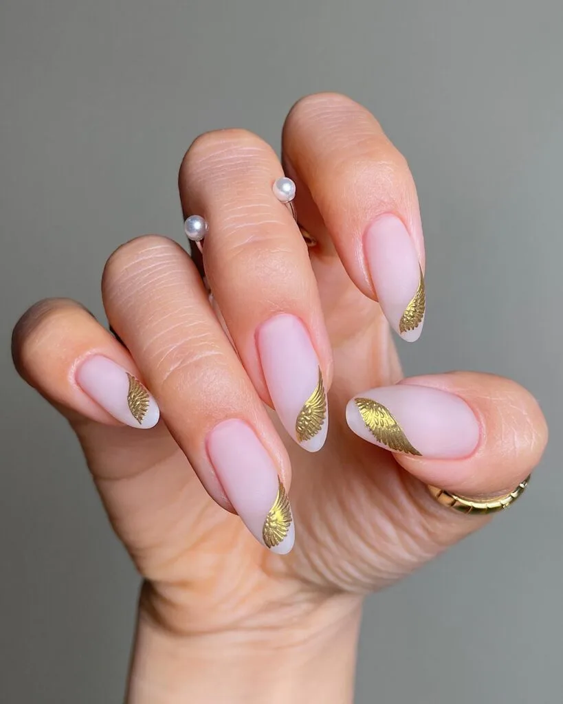 2026 nail trends, soft pink nails with gold foil accents and silver pearl rings