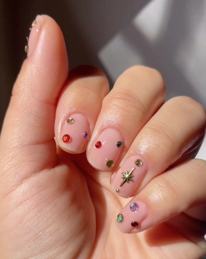 2026 nail trends, short pink nails with colorful gemstone accents