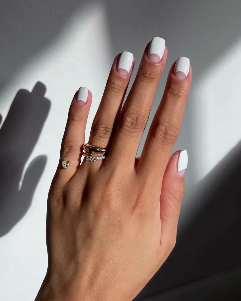 old money nails in white polish with negative space half moon on short square nails