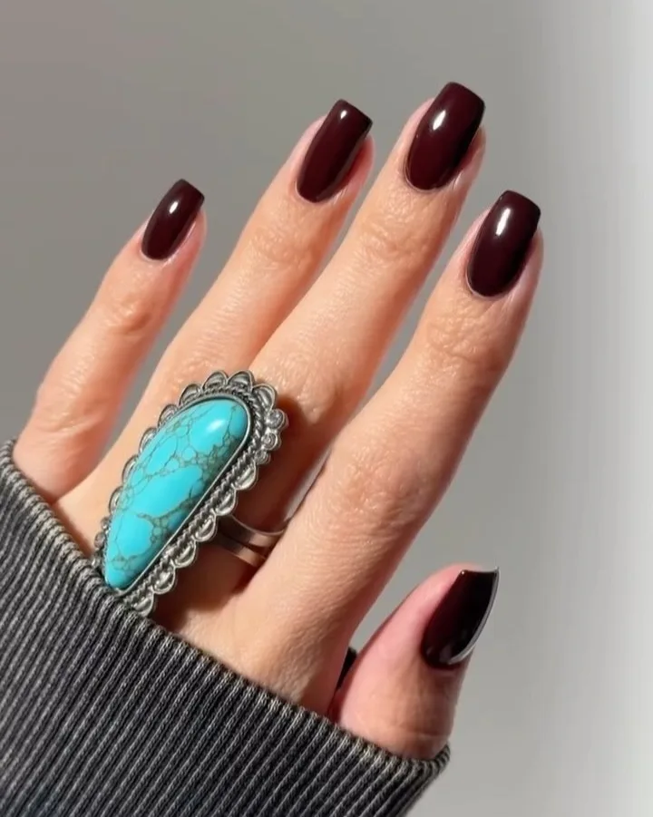 old money nails in deep glossy oxblood on medium square nails with turquoise ring